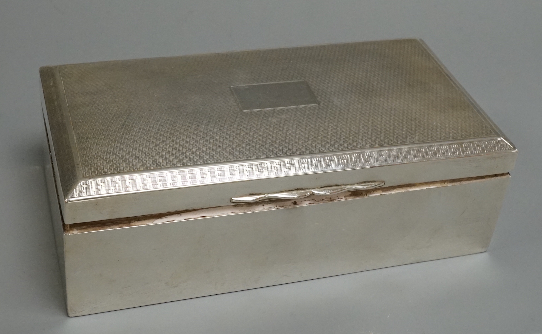 A George V silver mounted rectangular cigarette box, Birmingham, 1928, 17.2cm.